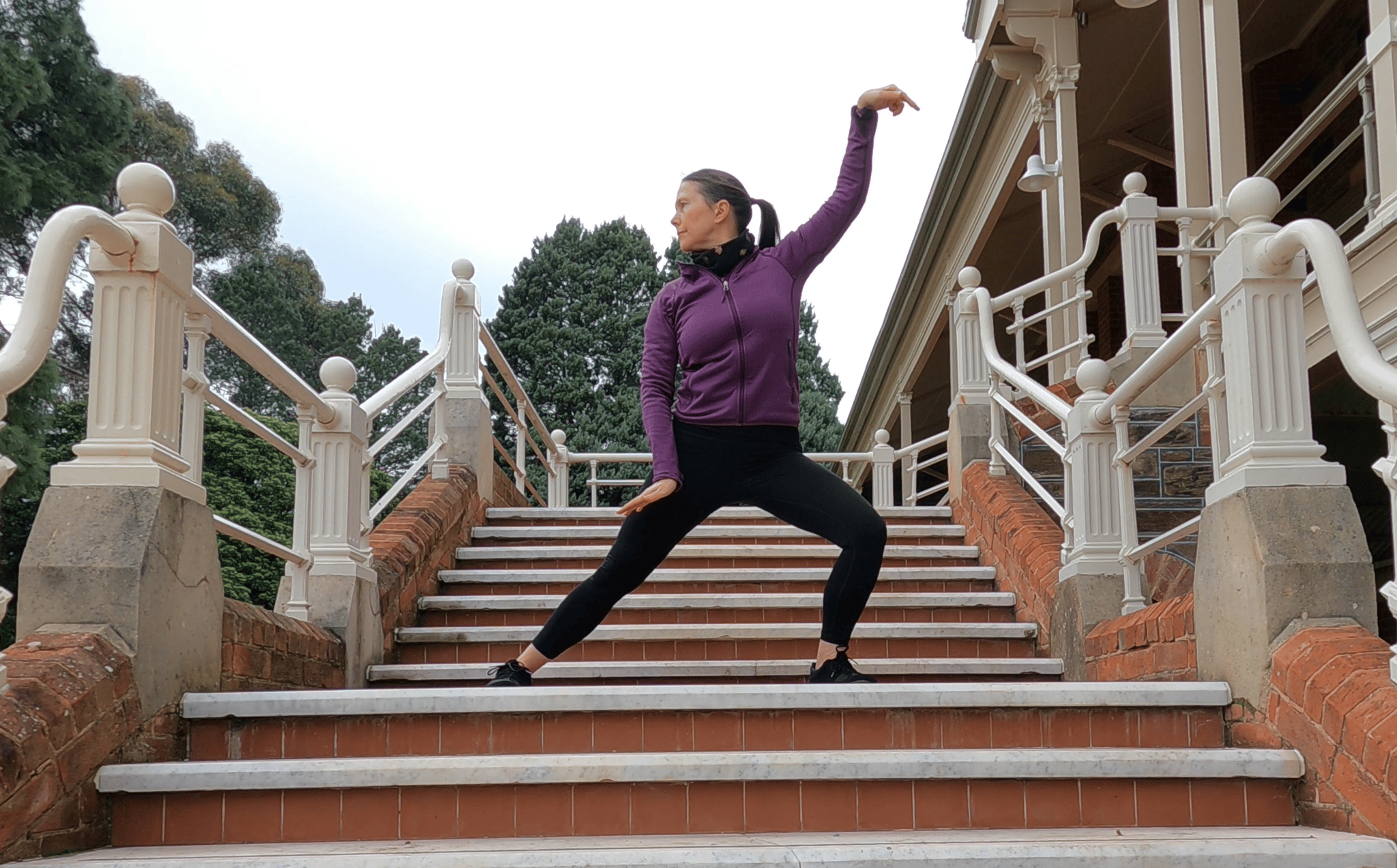 A woman on a staircase practicing Snake Qigong