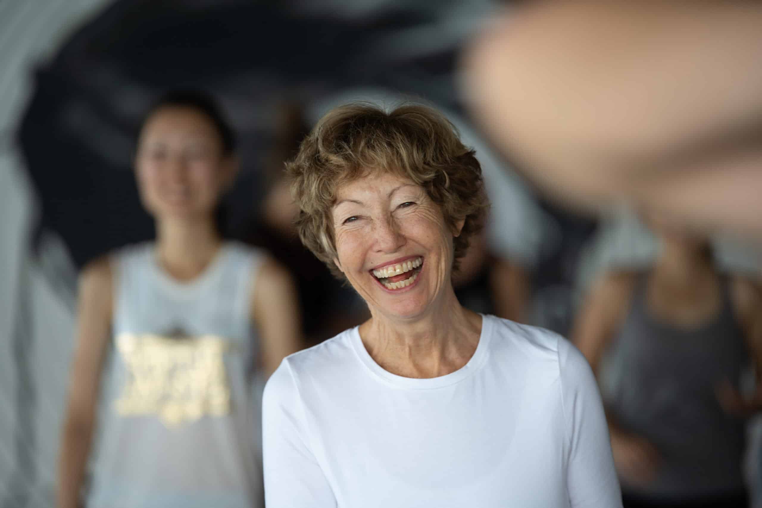 Qigong for Seniors - A senior woman smiling during qigong class 