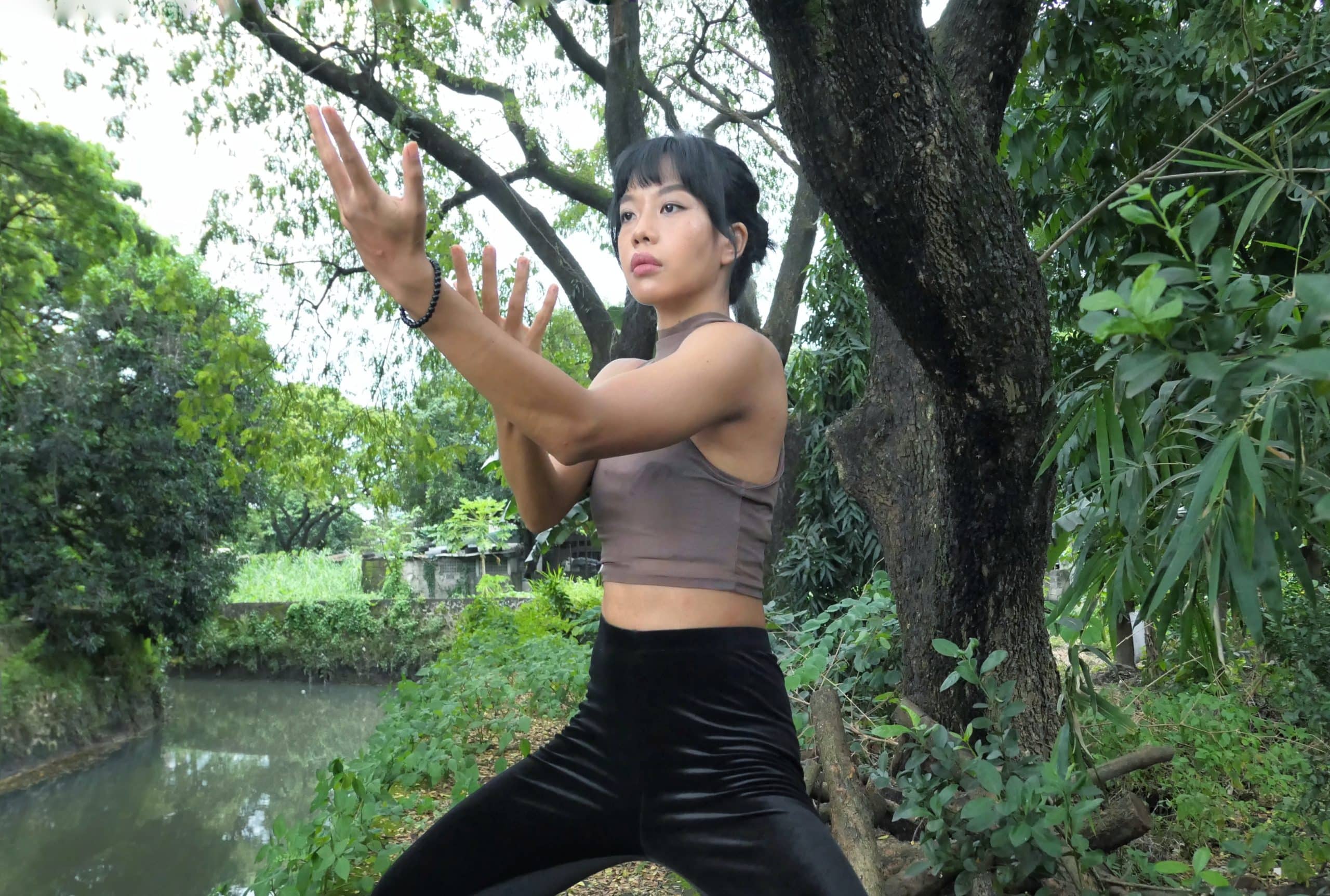 A dancer practicing qigong surrounded by nature